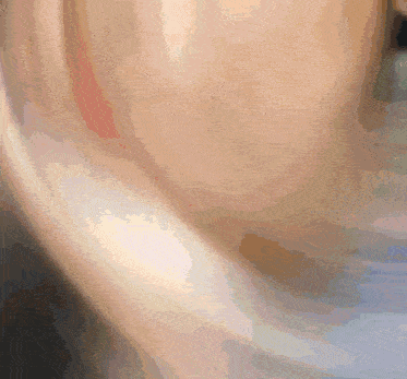 a close up of a person 's ear with a blurred background