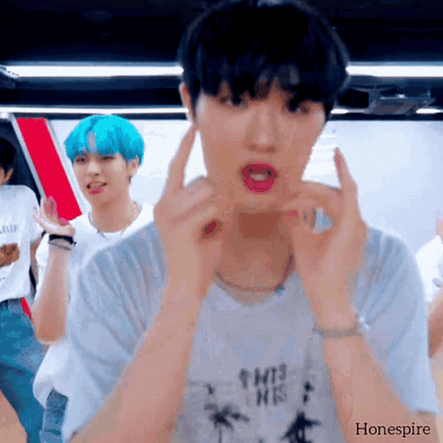 a boy with blue hair is wearing a white shirt that says " this is his "