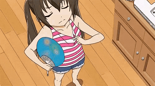 a girl in a striped tank top and shorts is holding a fan in her hand .