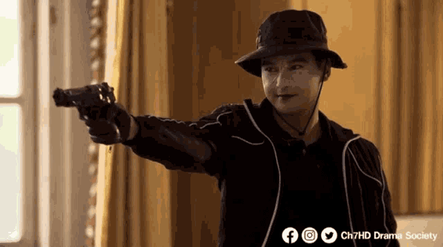 a man in a hat is pointing a gun at the camera with the words ch7hd drama society behind him