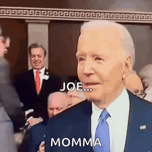 a man in a suit and tie is talking to a group of people and says joe ... momma .