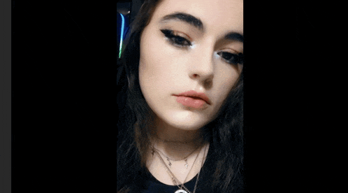 a close up of a woman 's face with makeup on