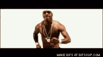 a man without a shirt is standing in front of a white background and making a fist .
