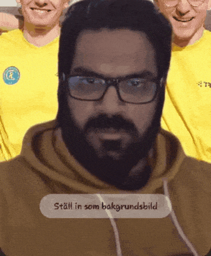 a man with glasses and a beard has a sticker that says still in som bakgrundsbild
