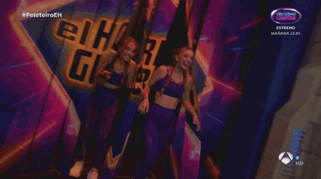 a woman is dancing on a stage in front of a screen that says twin melody