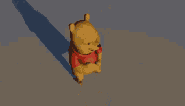 winnie the pooh is jumping in the air