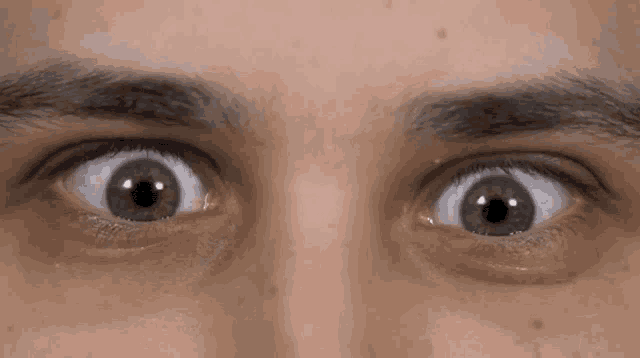 a close up of a man 's eyes with a slight swirl