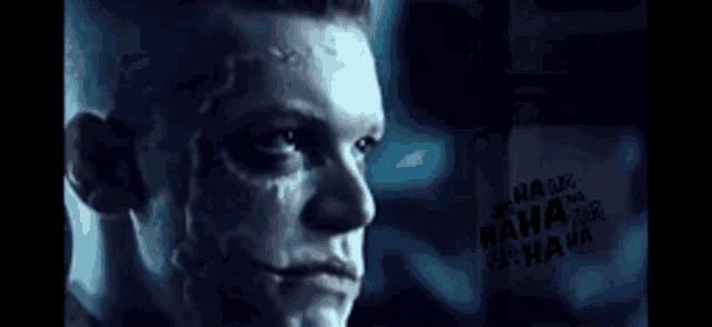 a close up of a man 's face with the words " ha ha ha ha " written on the bottom