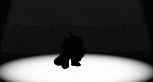 a silhouette of a person standing in the dark