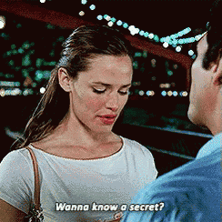 a woman in a white shirt is talking to a man in a blue shirt and says " wanna know a secret "