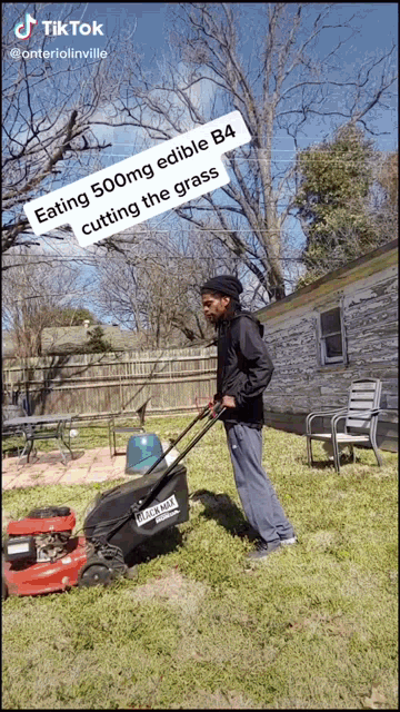 a man is pushing a lawn mower in a backyard with the caption " eating 500mg edible b4 "