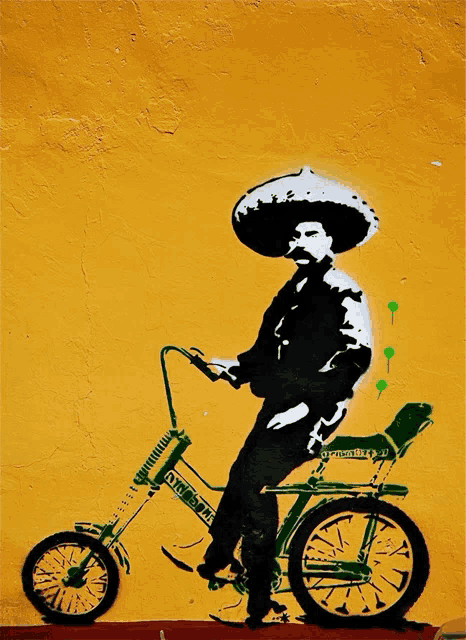 a man wearing a sombrero is riding a bicycle that says " old school " on the front