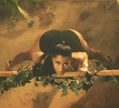 a woman in a black swimsuit is laying on a wooden railing