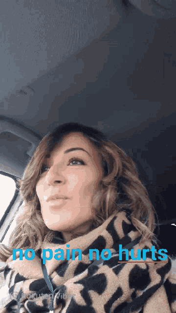 a woman in a car with the words " no pain no hurts " on the bottom
