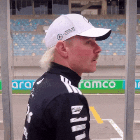a man wearing a white hat with mercedes benz on it