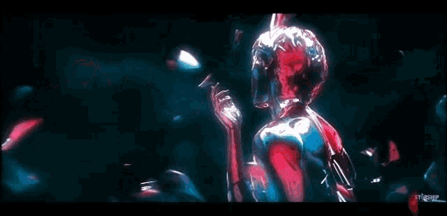 a woman in a red dress is standing in a dark room with a blue background .