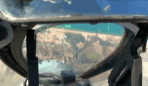 a view of a beach from inside a helicopter