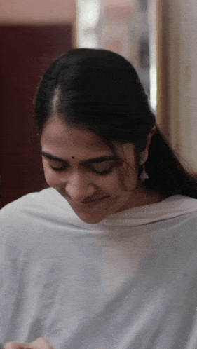 a close up of a woman wearing a white shawl