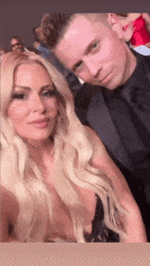 a man and woman are posing for a picture together .