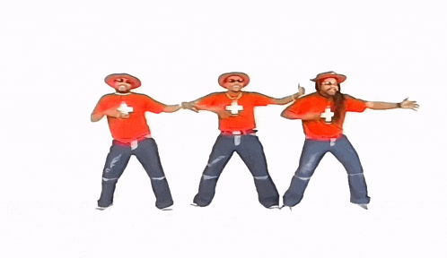 a group of men wearing red shirts with swiss crosses on them are dancing