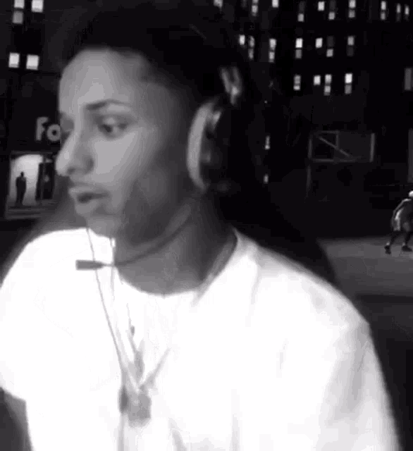 a man wearing headphones is playing a video game .