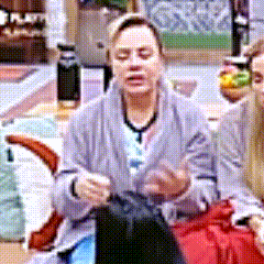 a woman in a gray robe is sitting on a chair