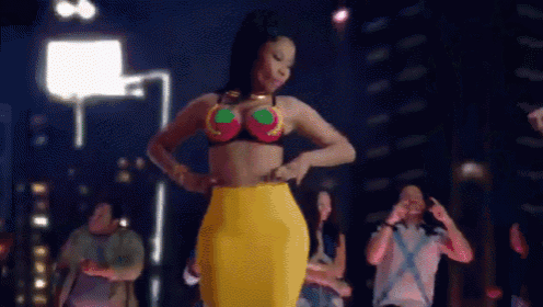 a woman in a bikini top and yellow skirt is dancing