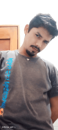 a man wearing a t-shirt that says infinix hot on it