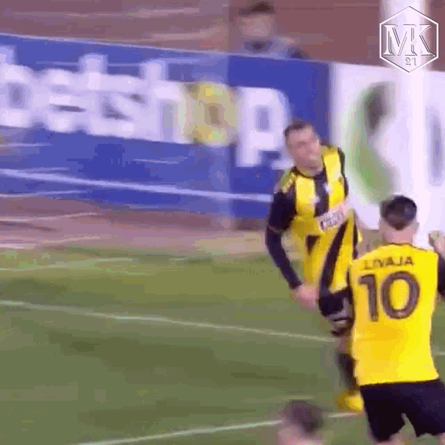 a soccer player wearing a yellow jersey with the number 10