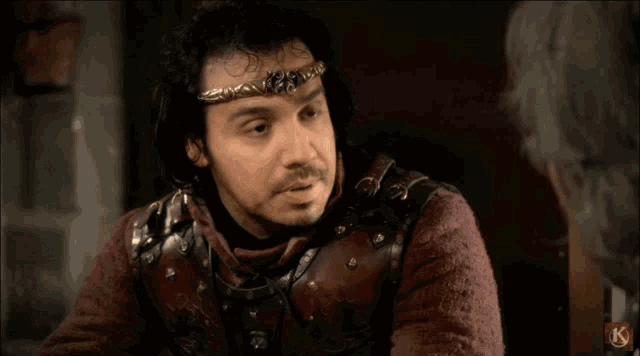 a man with a crown on his head says je vous aime in a foreign language