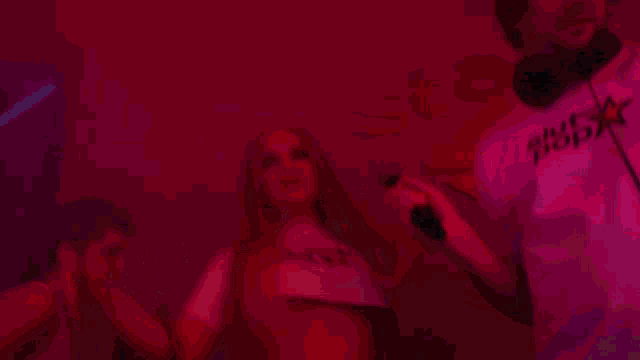 a woman singing into a microphone with a shirt that says slut bop