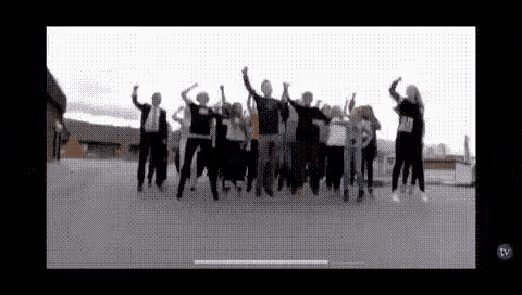a group of people are jumping in the air with their arms in the air