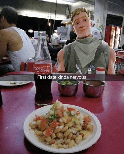 a bottle of coca-cola sits on a table next to a plate of food