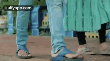 a man and a woman are standing next to each other on the street .