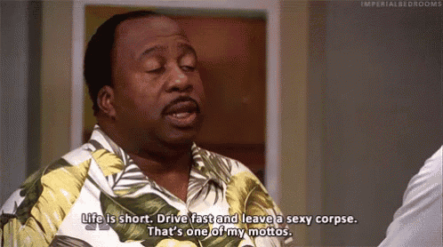 a man in a hawaiian shirt is saying `` life is short , drive fast and leave a sexy corpse . ``