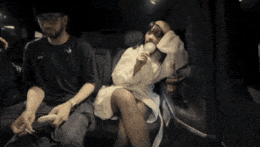 a woman sitting in the back seat of a car eating ice cream