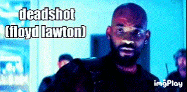 a man with a beard is standing in front of a sign that says deadshot floyd lawton