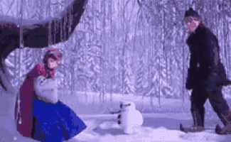 a man and a woman are playing in the snow .