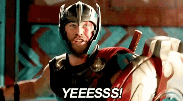 thor is wearing a helmet and holding a shield and saying yeeess .
