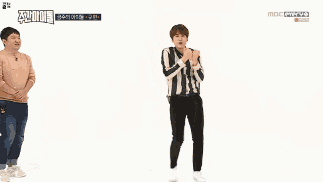 a man in a striped shirt is dancing in front of a mbc everyo screen