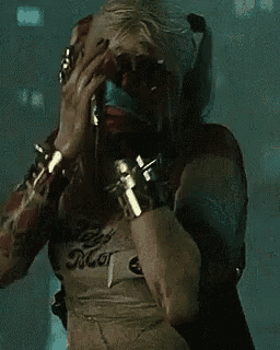 harley quinn is wearing a shirt that says daddy 's little monsters .