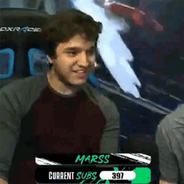 a man is standing in front of a screen that says current subs 397 .