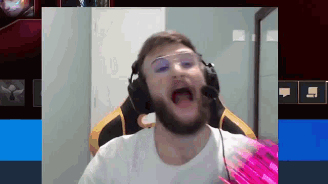 a man with a beard wearing headphones and glasses is making a funny face
