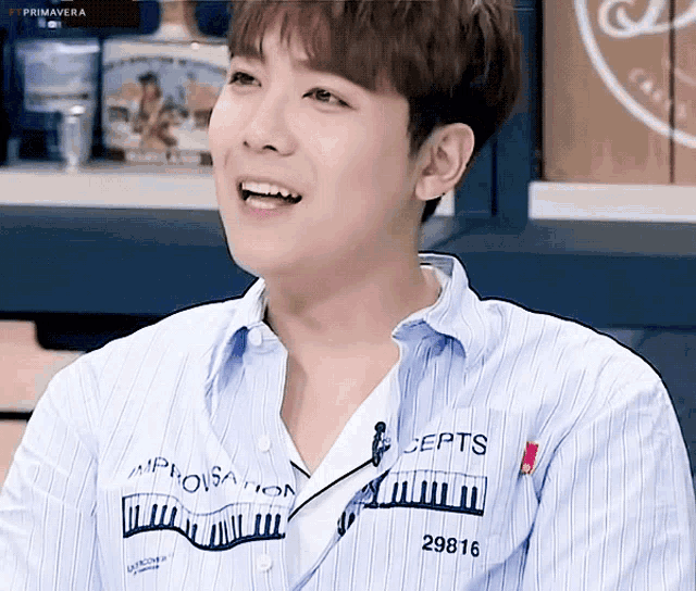 a young man wearing a striped shirt that says concepts