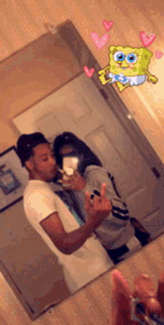a man and a woman are taking a picture of themselves in the mirror