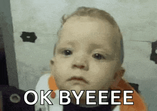 a baby is making a funny face and saying ok byeee .