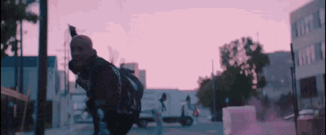 a man is riding a skateboard down a city street .