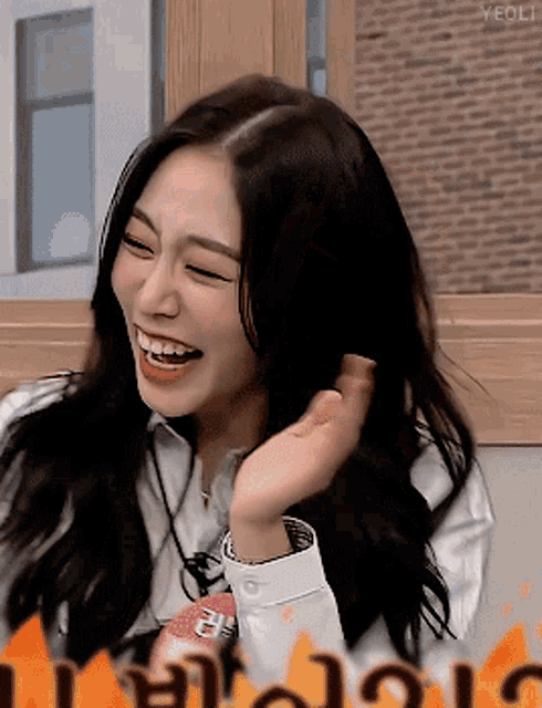 a woman is laughing with the word yeoli in the corner