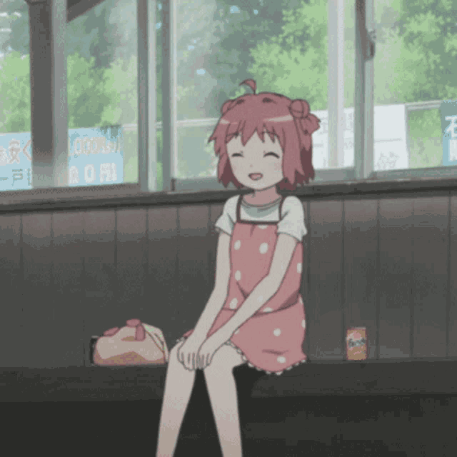 a girl in a pink dress sits in front of a window