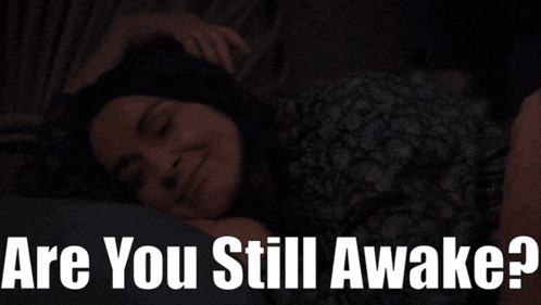 a woman laying in bed with the words are you still awake